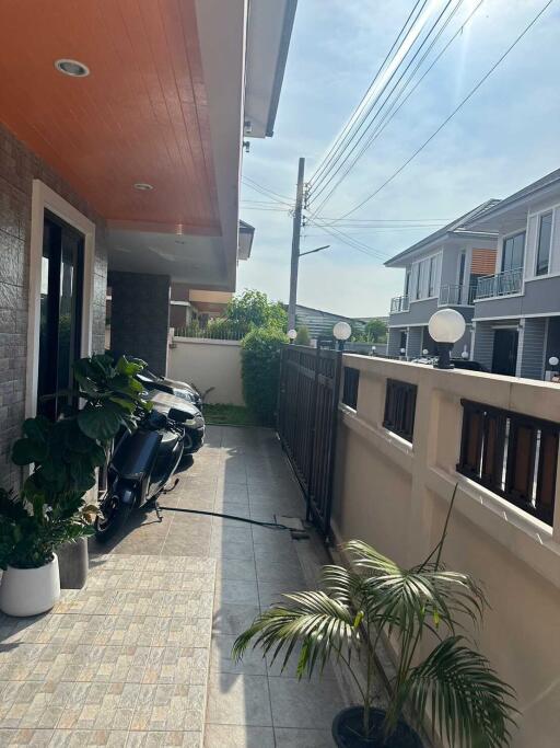 Front porch with plants and motorcycles