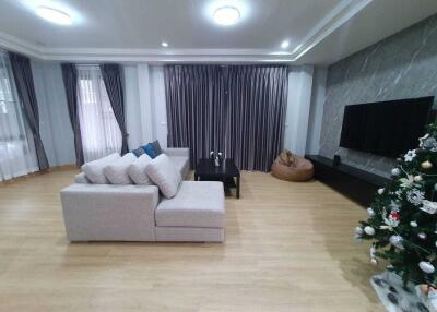 Modern living room with sectional sofa and Christmas tree
