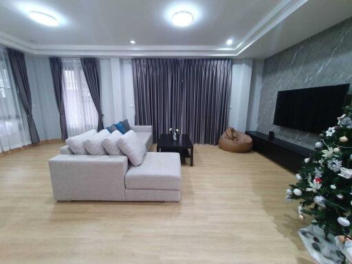 Modern living room with sectional sofa and Christmas tree