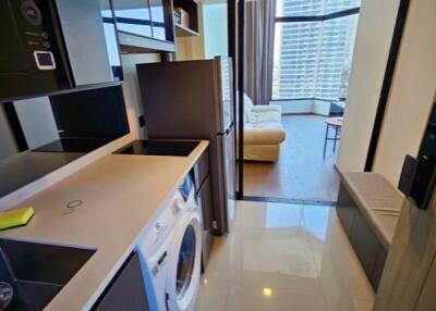 Modern kitchen leading to a living room