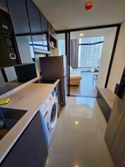 Modern kitchen leading to a living room