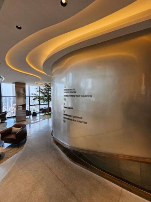 Modern building interior with lounge area and directional signage