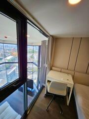 Modern bedroom with study area and city view