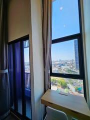 Bedroom with large windows and city view