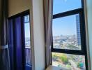 Bedroom with large windows and city view