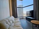 Living room with large windows and city view