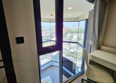 Cozy bedroom with balcony and city view