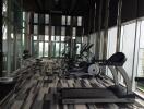 Modern gym with large windows and exercise equipment