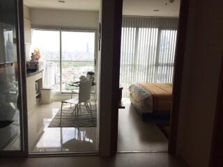 Apartment with a view of the city, showing a dining area and bedroom