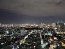 Night view of a city skyline with illuminated buildings