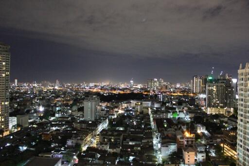 Night view of a city skyline with illuminated buildings