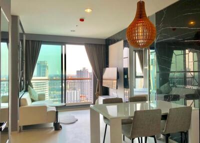 Modern living room and dining area with large windows and city view