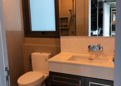 Modern bathroom with a large window, sink, and toilet