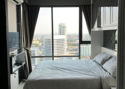 Modern bedroom with large window and city view