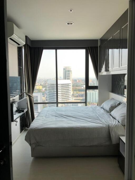 Modern bedroom with large window and city view