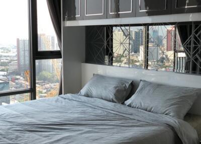 Modern bedroom with large windows and city view