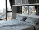 Modern bedroom with large windows and city view