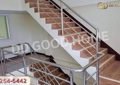 Indoor staircase with wooden steps and metal railings