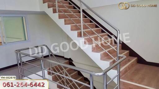 Indoor staircase with wooden steps and metal railings