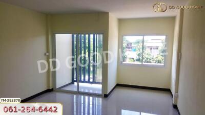 Spacious living room with large windows and sliding door to the balcony