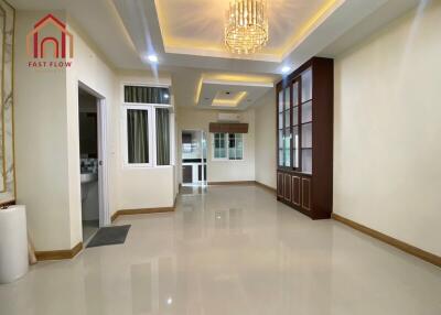 Spacious modern living room with chandelier and glossy tiled floor