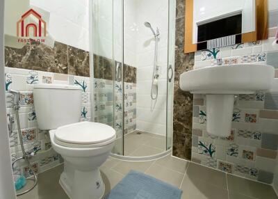 Modern bathroom with shower, toilet, and sink