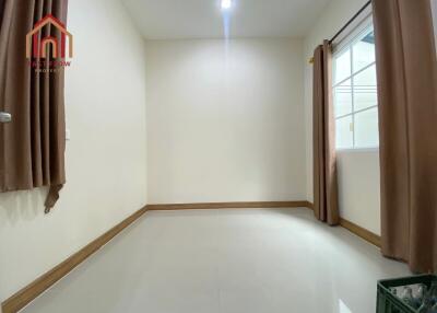 Empty unfurnished bedroom with window and brown curtains