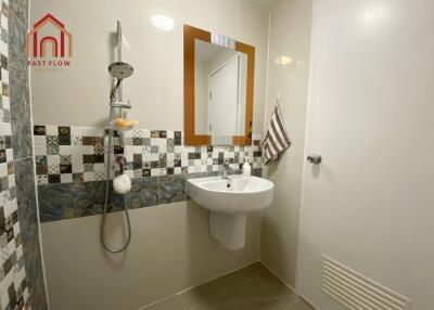 Bathroom with modern fixtures and decorative tiles