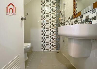 Modern Bathroom with Tiled Wall and White Sink