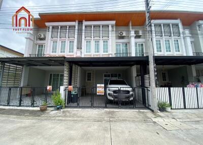 Front view of residential townhouses with parking spaces