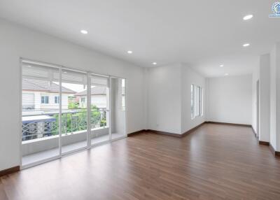 Spacious and well-lit living area with wooden flooring