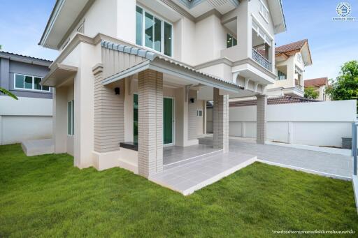 Modern two-story house with a lawn and covered entrance