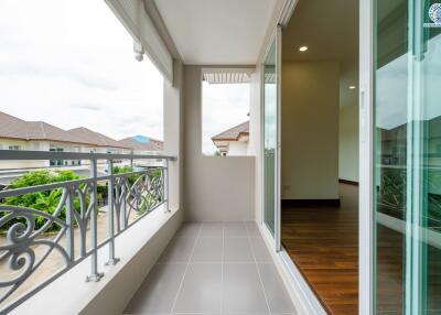 Balcony with a view of neighboring buildings and partly open sliding doors