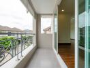 Balcony with a view of neighboring buildings and partly open sliding doors