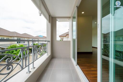 Balcony with a view of neighboring buildings and partly open sliding doors