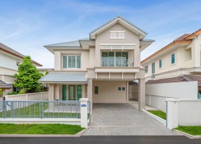 Modern two-story house exterior with driveway and lawn