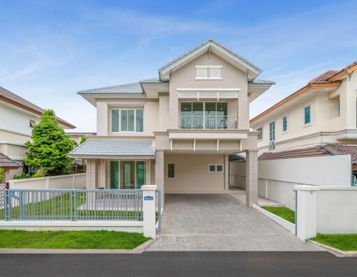 Modern two-story house exterior with driveway and lawn