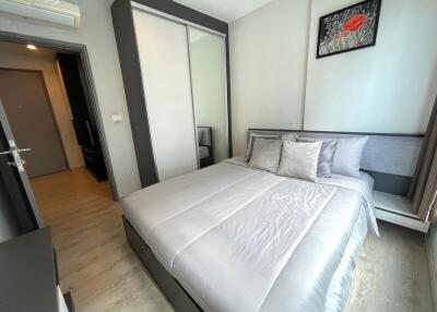 Modernly furnished bedroom with a large bed and wardrobe