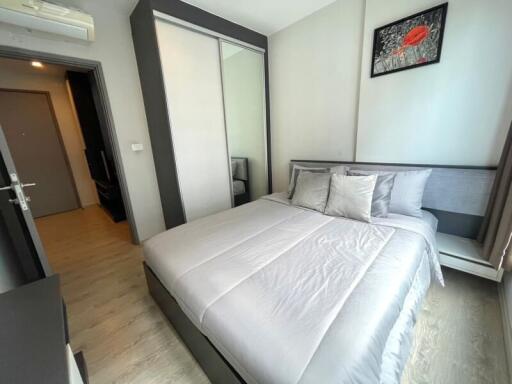 Modernly furnished bedroom with a large bed and wardrobe