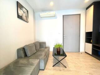 Modern living room with grey sofa and glass coffee table