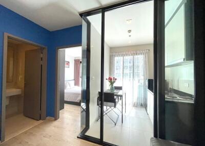 Modern apartment with glass partitions and blue accent wall