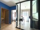 Modern apartment with glass partitions and blue accent wall