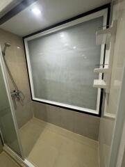 Modern bathroom shower with frosted window and beige tiles