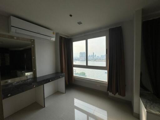 Bright bedroom with a large window and city view