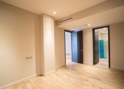 Spacious bedroom with wooden flooring and en-suite bathroom