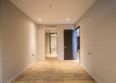 Modern hallway with wooden flooring and recessed lighting