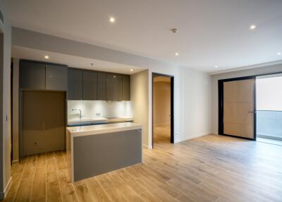 Modern open-area living space with kitchen and wooden flooring