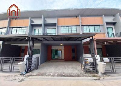 Modern townhouse exterior with garage and parking space