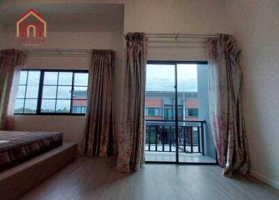 Bedroom with large windows and balcony