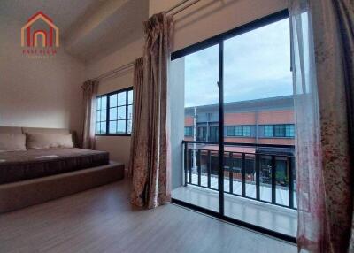 Modern bedroom with large windows and balcony access